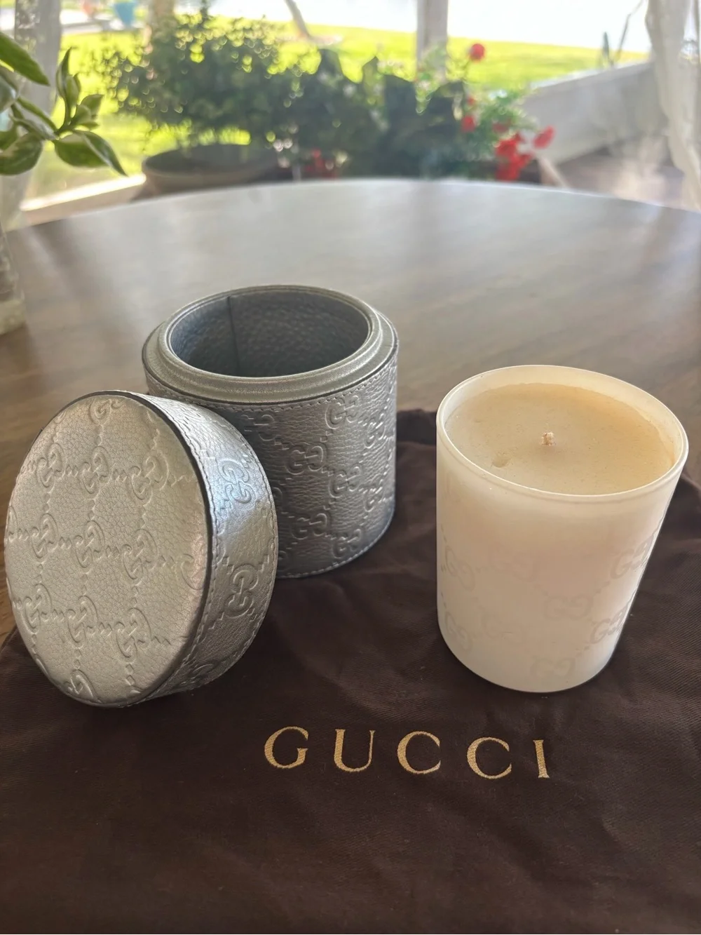 Gucci Candle Holder with lid and glass container with candle.